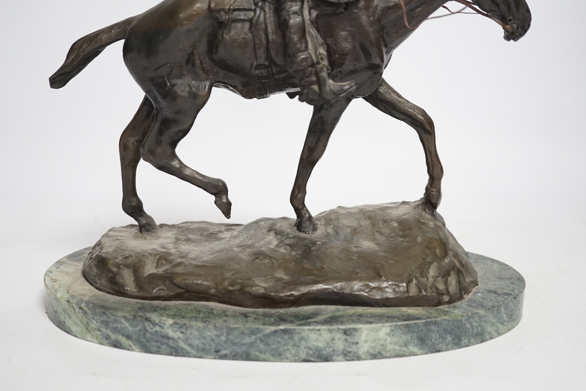 After Charles Marian Russell, a bronze group of Will Rogers, 29cm high